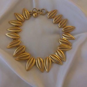 Gold Tone abstract necklace with toggle closure